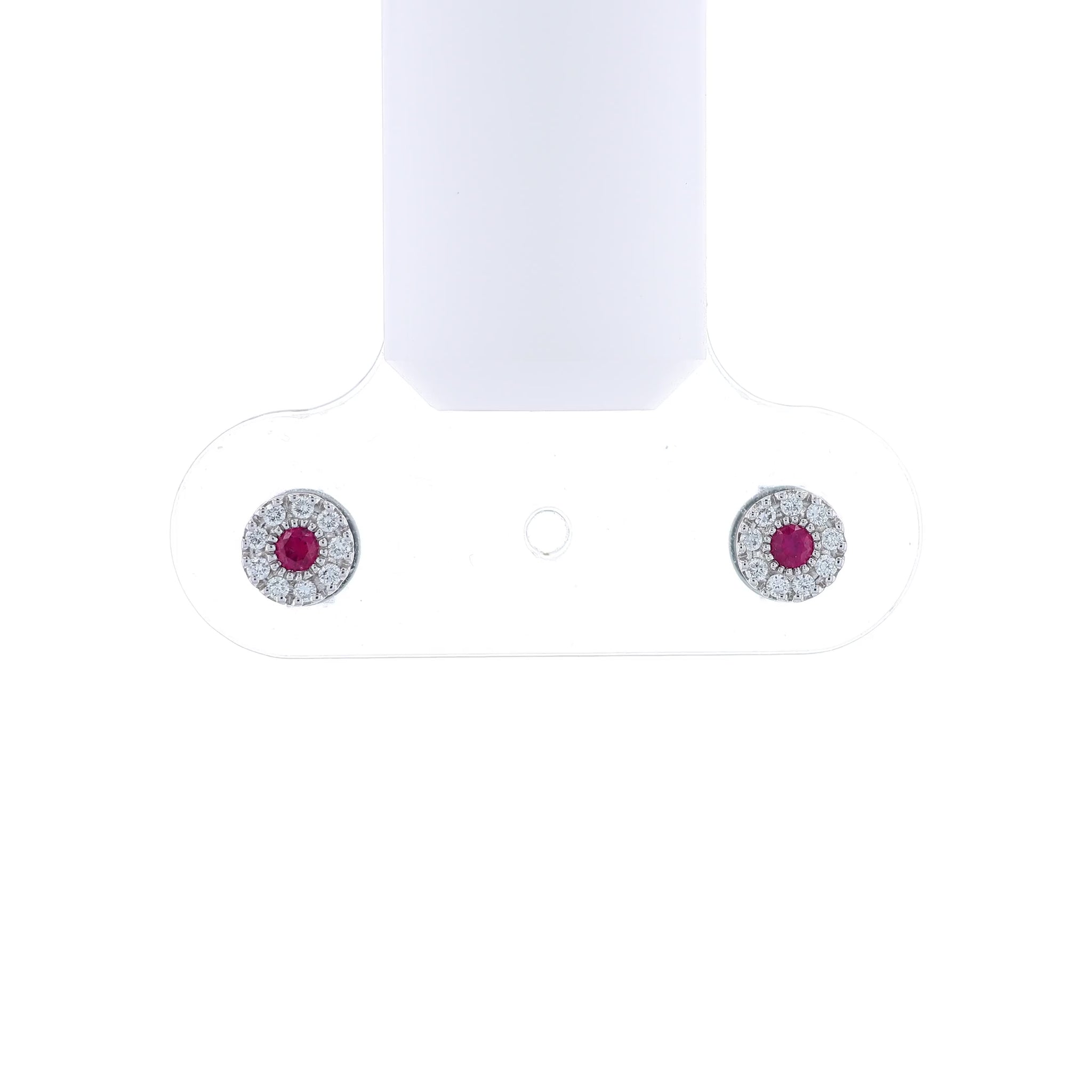 White gold round ruby and diamond halo stud earrings on a white background