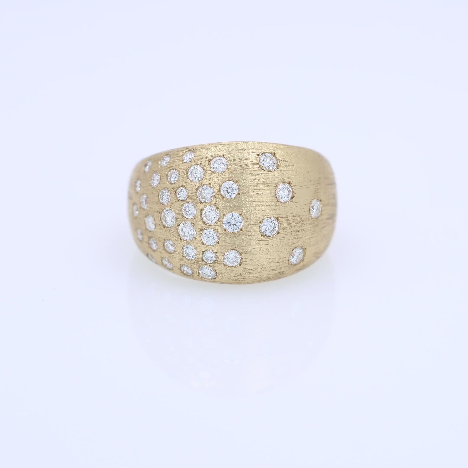 Gold ring with embedded diamonds on a white background