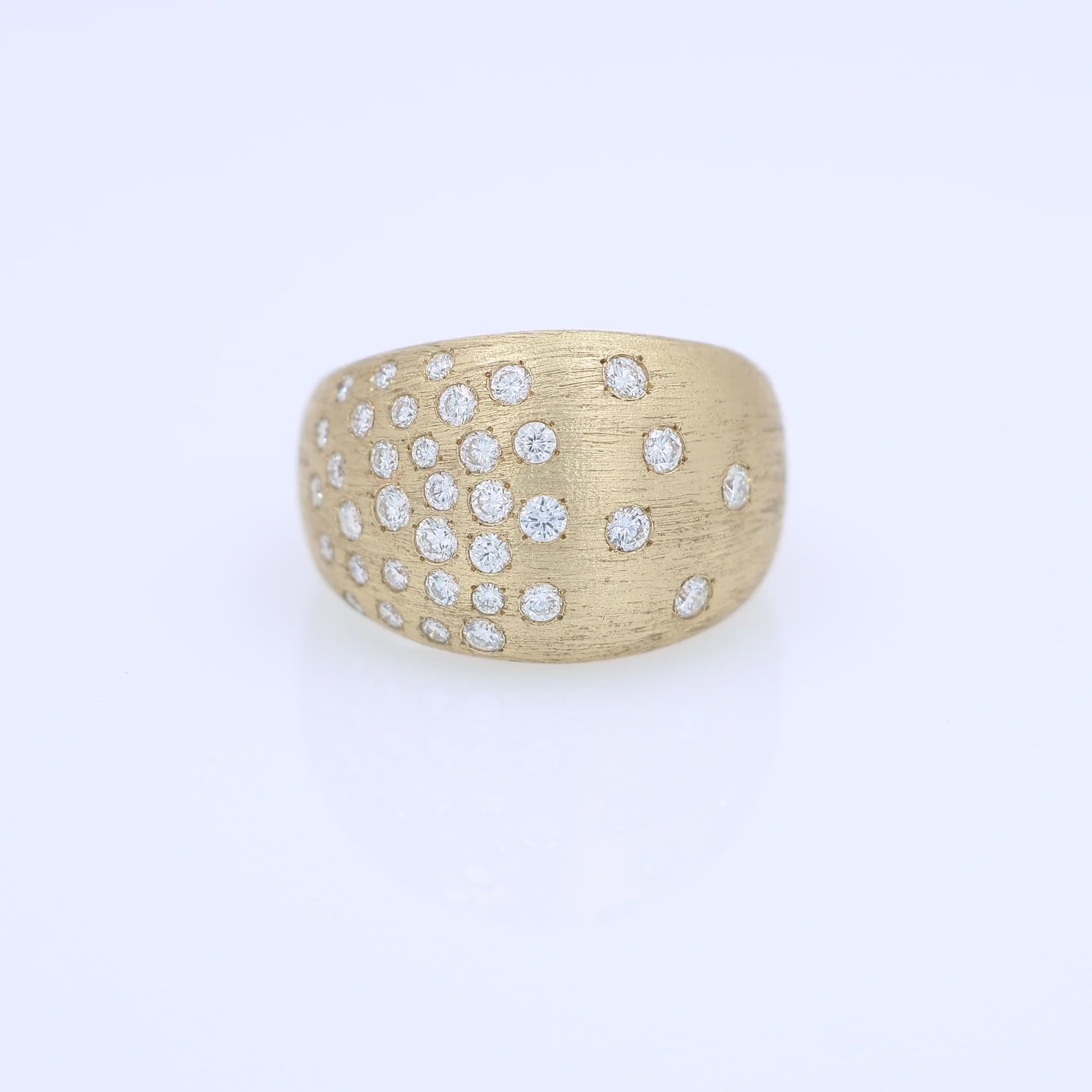 Gold ring with embedded diamonds on a white background