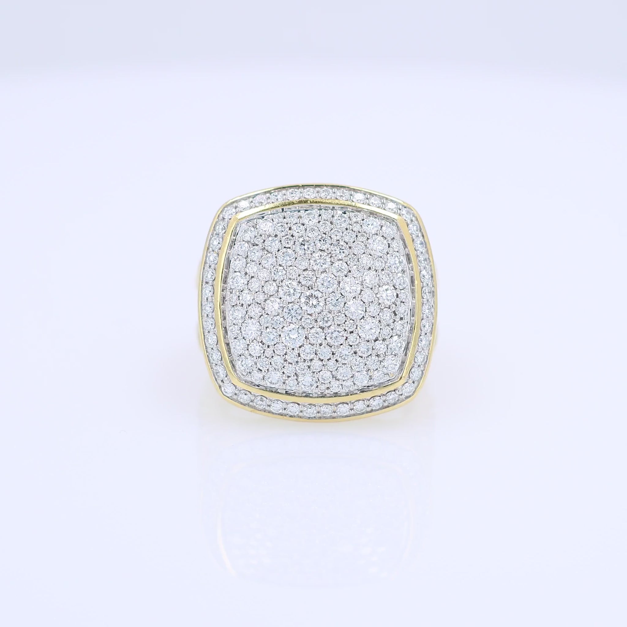A video of a yellow gold David Yurman signet ring featuring a square-shaped pavé diamond face and a twisted cable band, set against a clean white background.