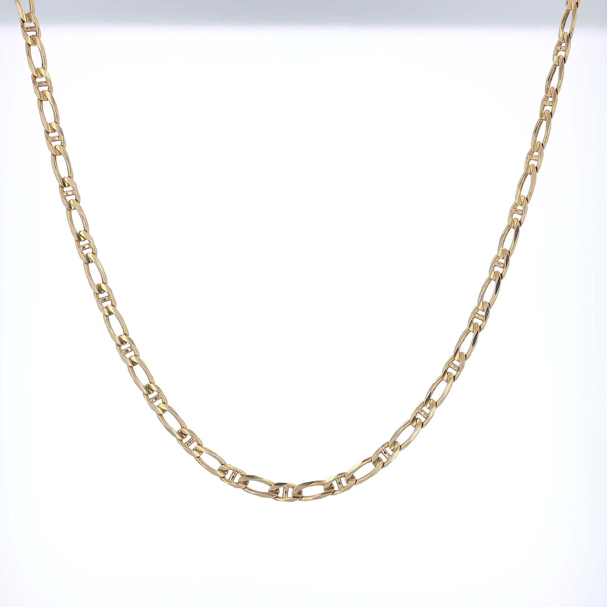 Yellow gold modified anchor link chain necklace on a white background