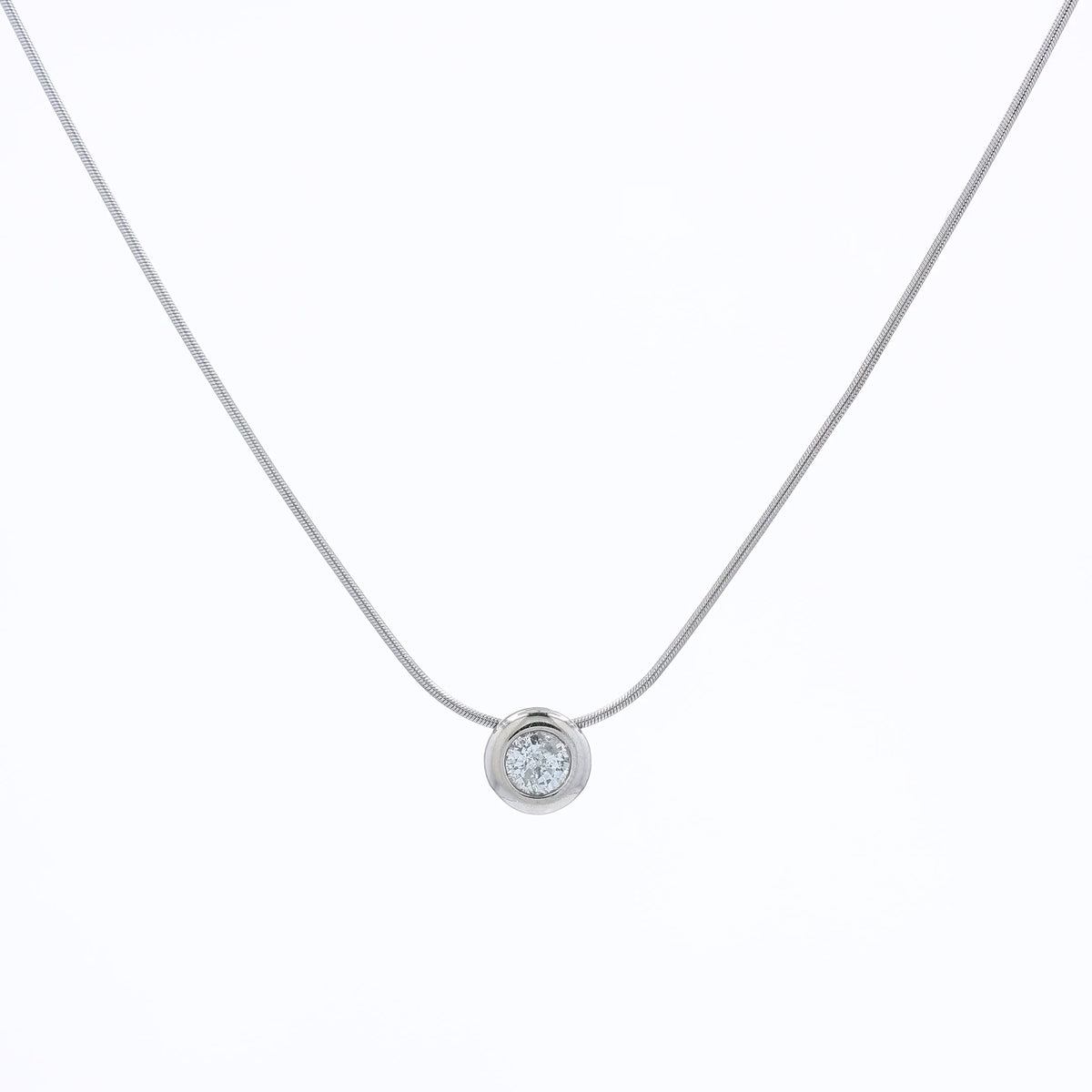 A delicate gold snake chain necklace with a single round bezel-set diamond pendant, displayed against a clean white background.