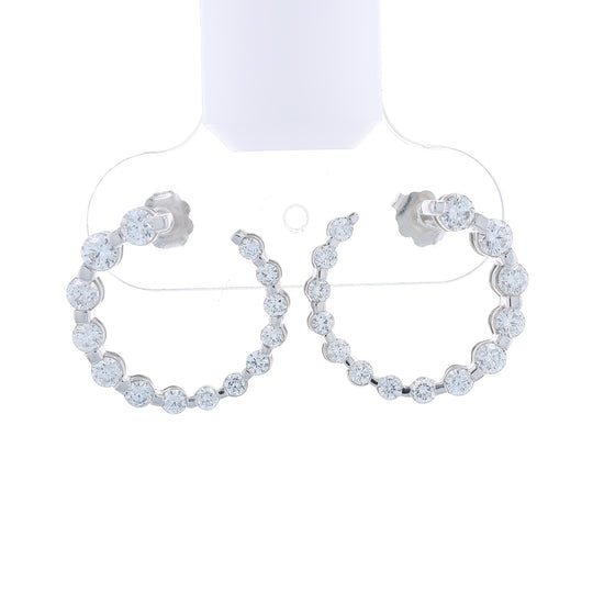 Pair of white gold drop earrings with graduated diamonds on a white background