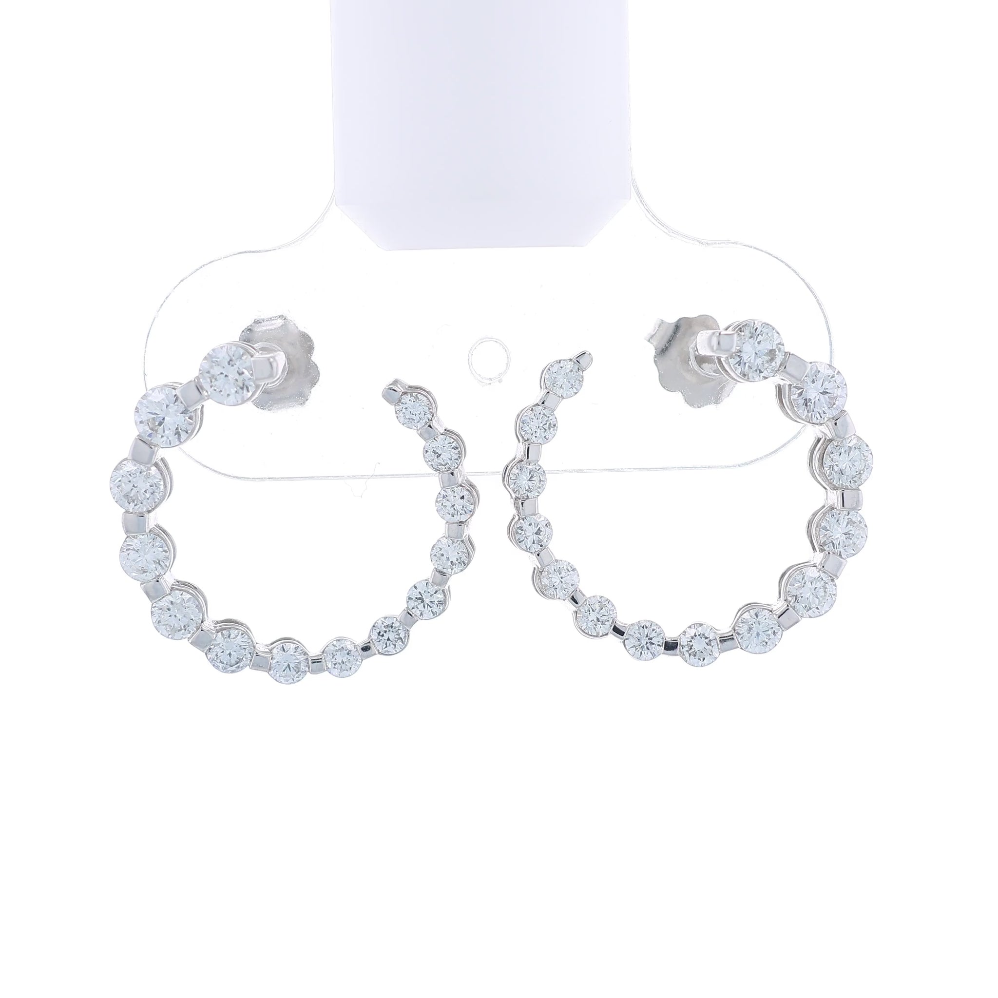 Pair of white gold drop earrings with graduated diamonds on a white background