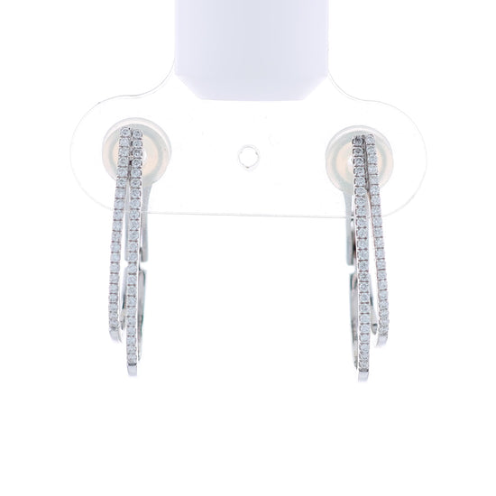 Pair of white gold 2 row diamond hoop earrings on a white background