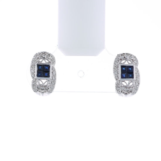 Pair of white gold diamond hoop earrings with multi-square blue sapphire centers on a white background