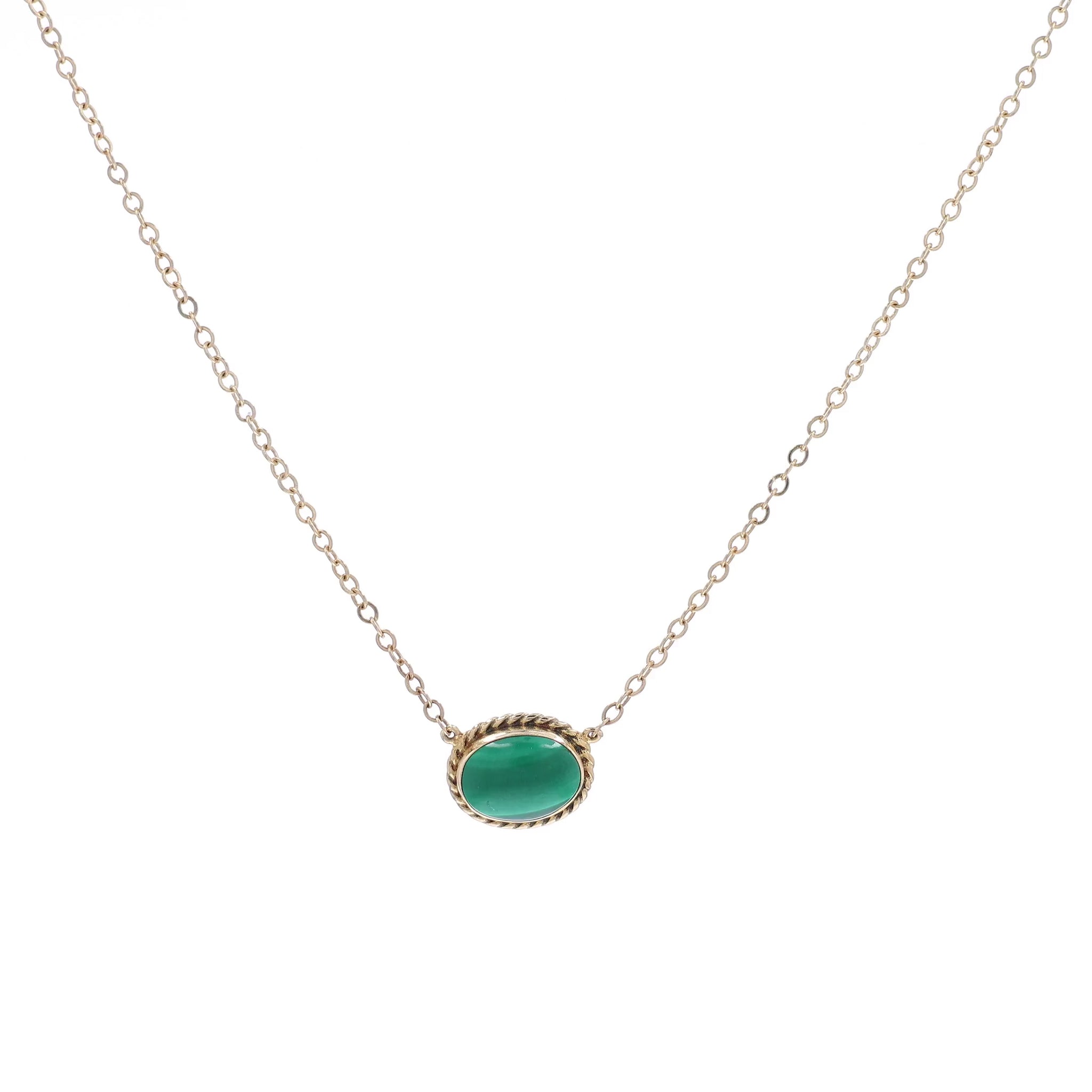 Yellow gold oval malachite pendant necklace on a white background