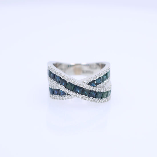 White gold crisscross design channel-set sapphire and diamond ring on a white background