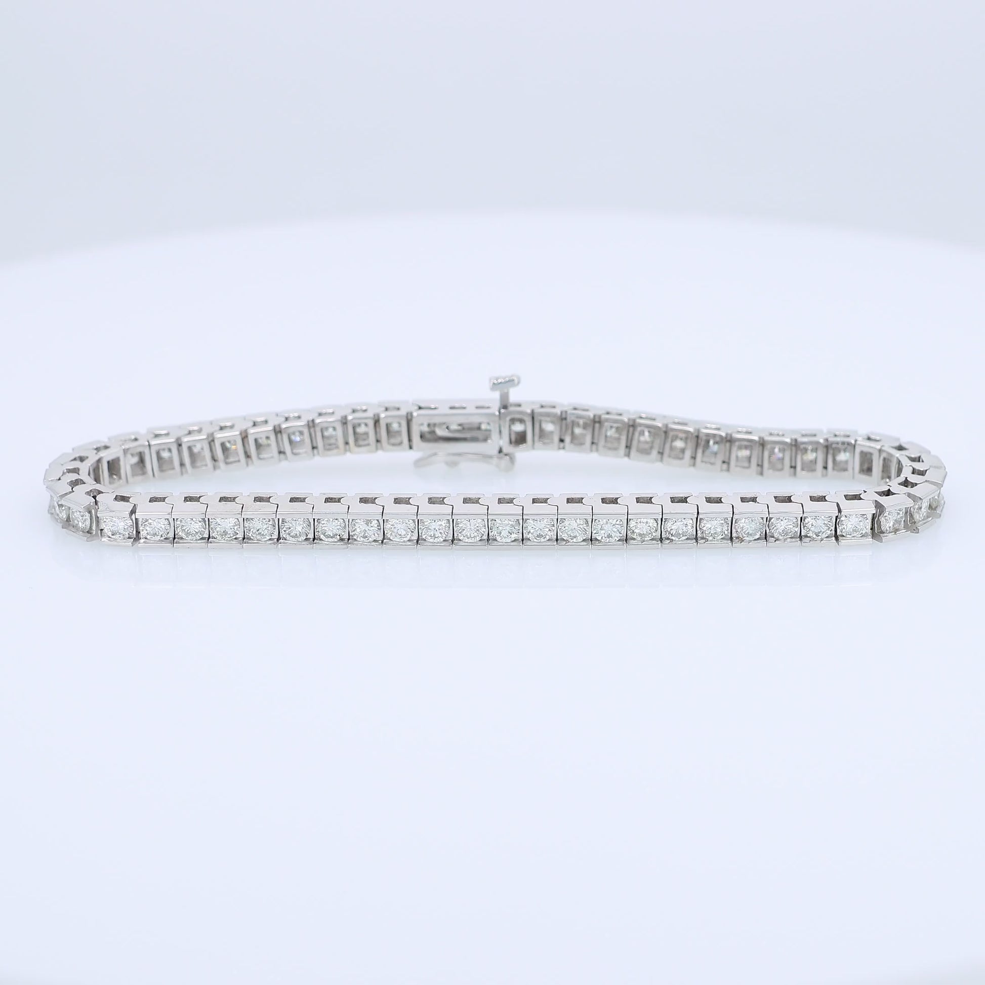 White gold channel set 5 carat diamond tennis bracelet on a white background