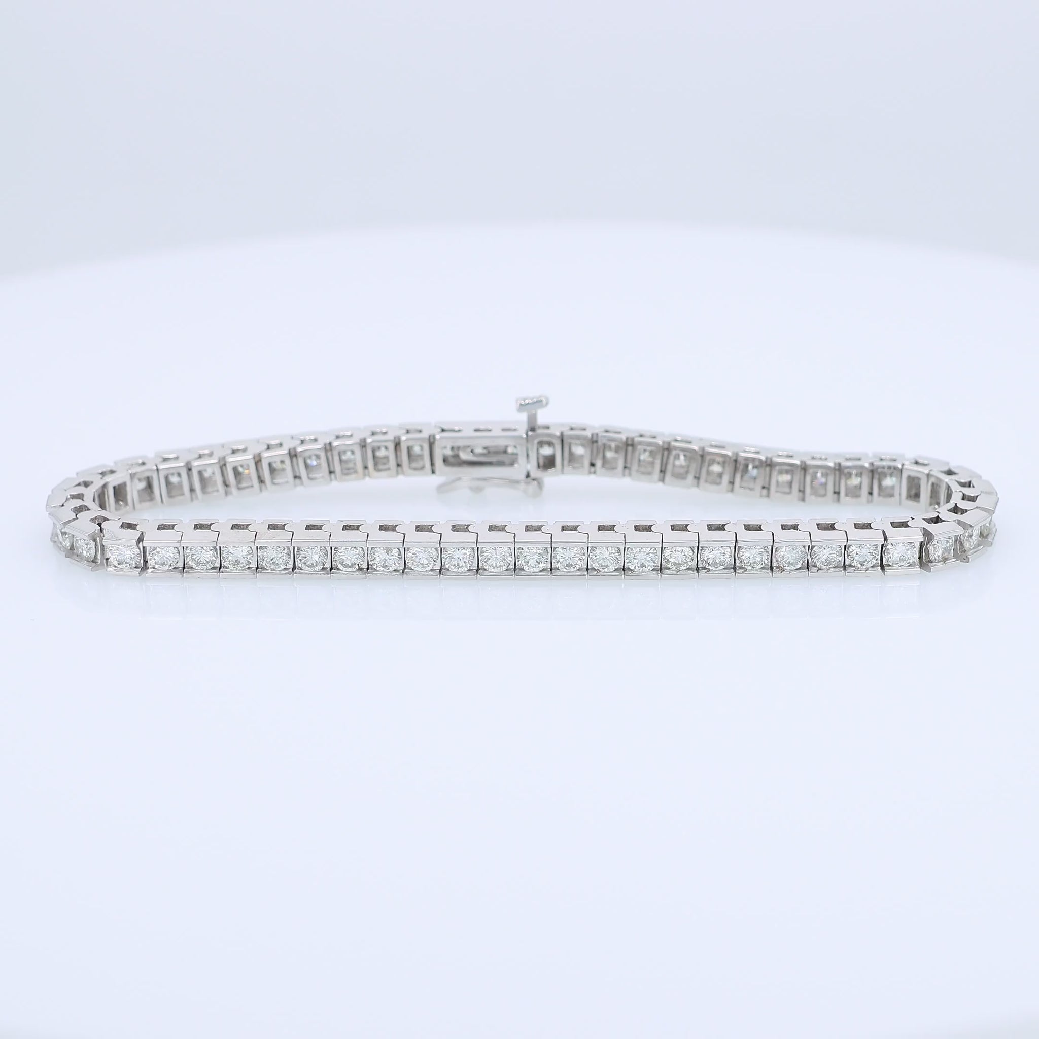 White gold channel set 5 carat diamond tennis bracelet on a white background