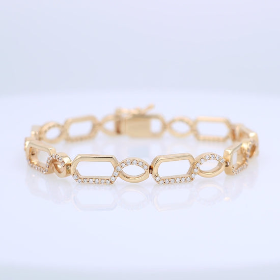 Gold bracelet with half and half diamond accent and polished gold design on a white background