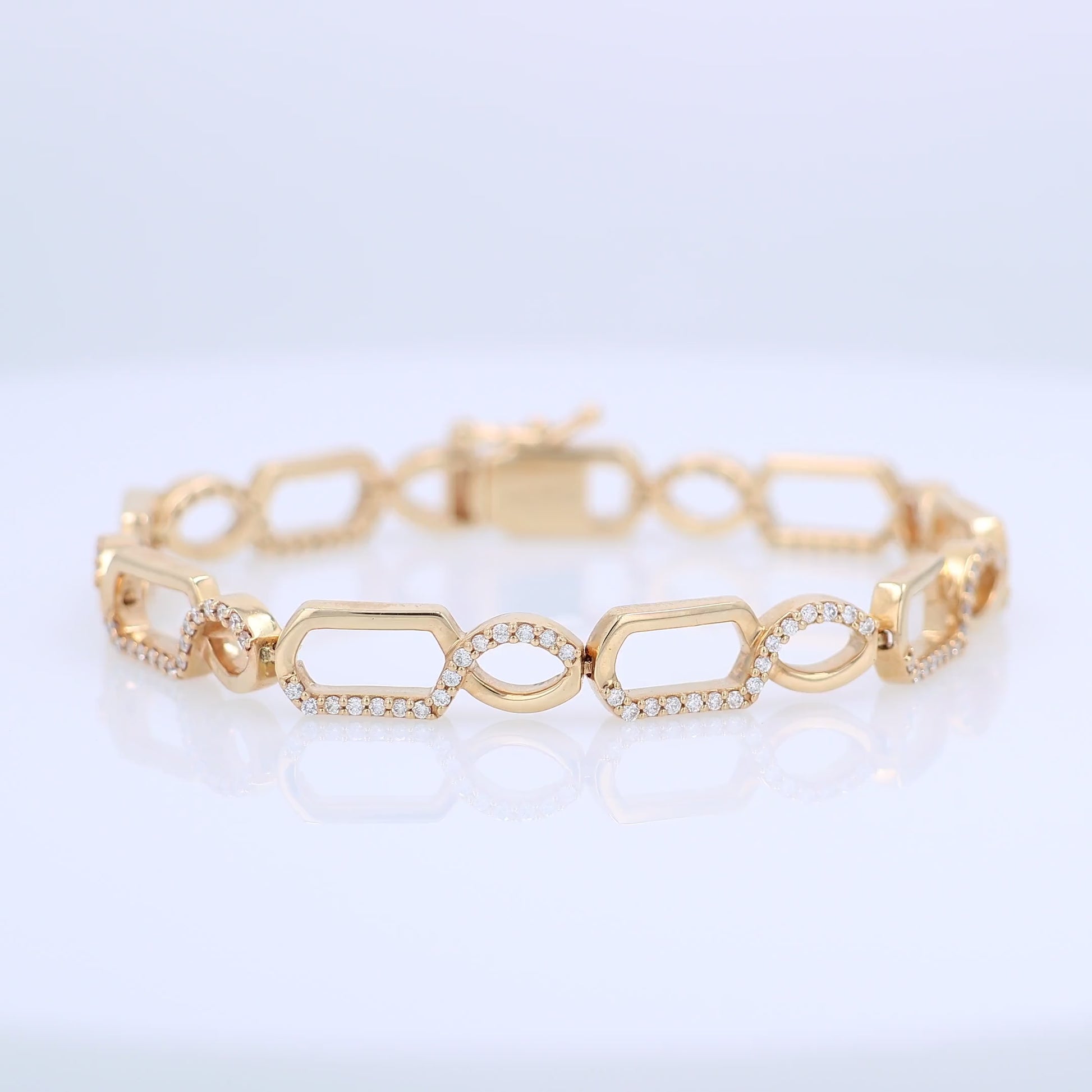 Gold bracelet with half and half diamond accent and polished gold design on a white background