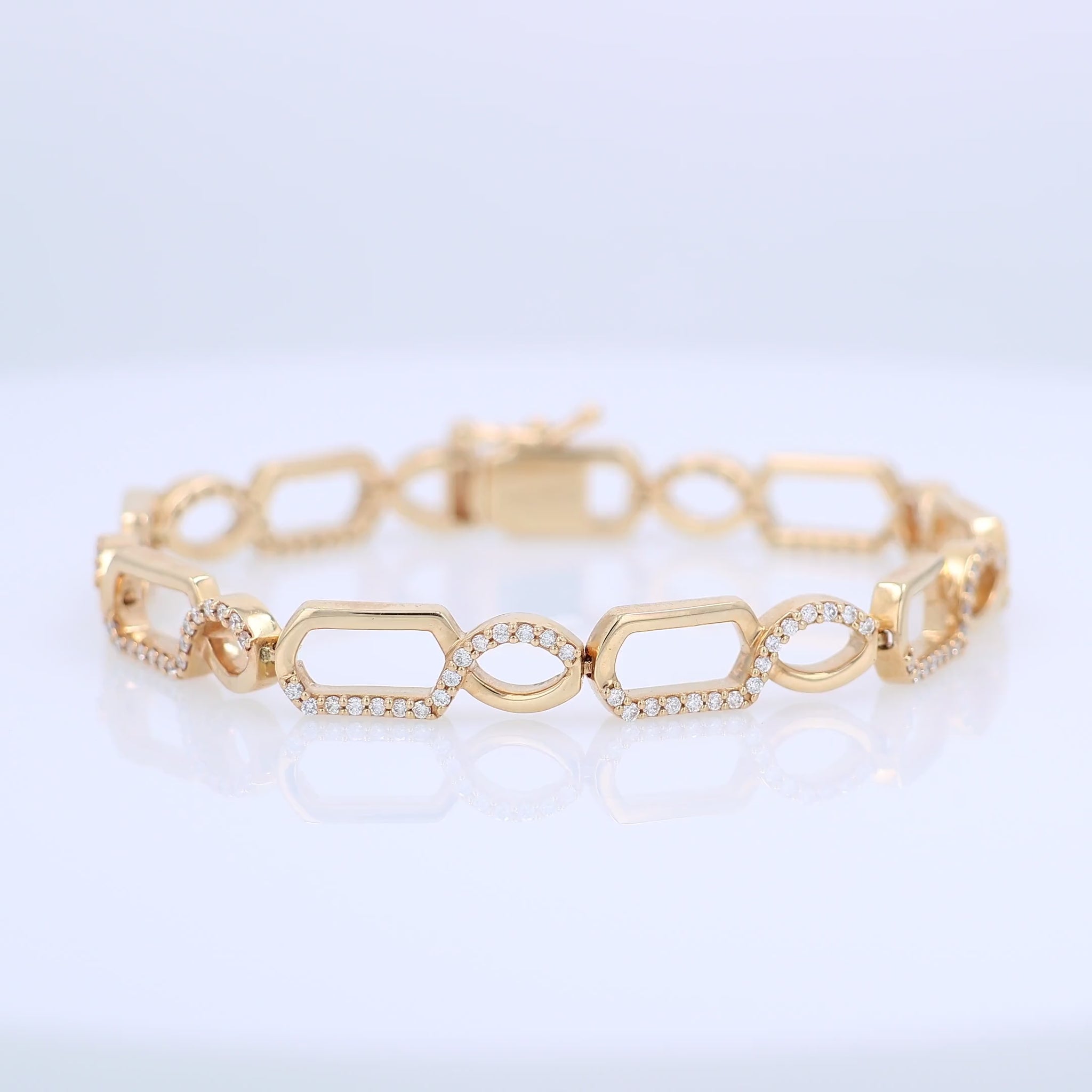Gold bracelet with half and half diamond accent and polished gold design on a white background