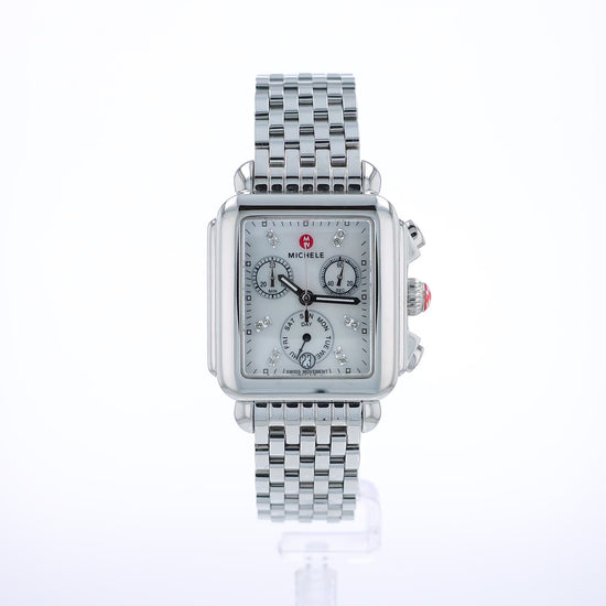 360 degree video of a silver Michele watch with a mother of pearl and diamond dial on a white background