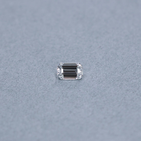 Emerald cut 1.52 carat GIA certified diamond graded FVS2 on a grey background