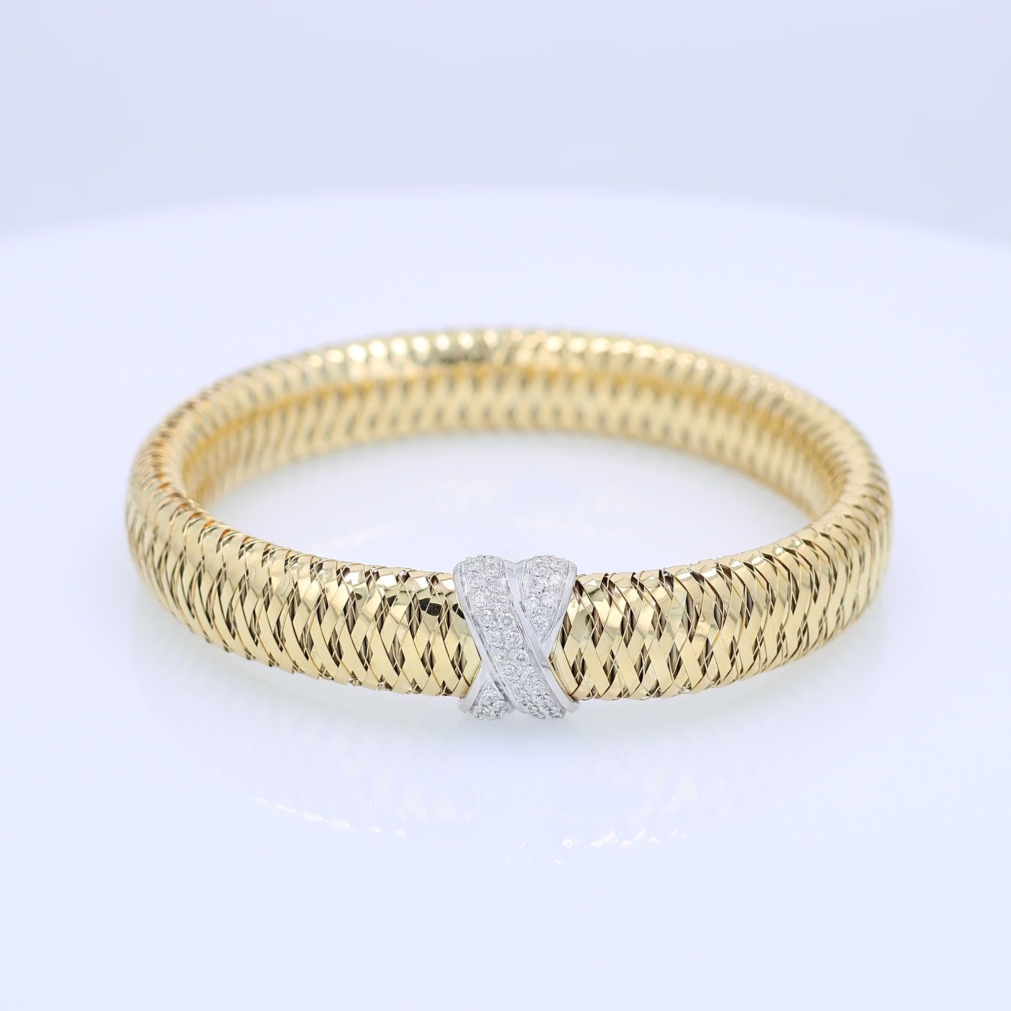 Roberto Coin two-tone gold diamond "X" link flex tubogas bracelet on a white background