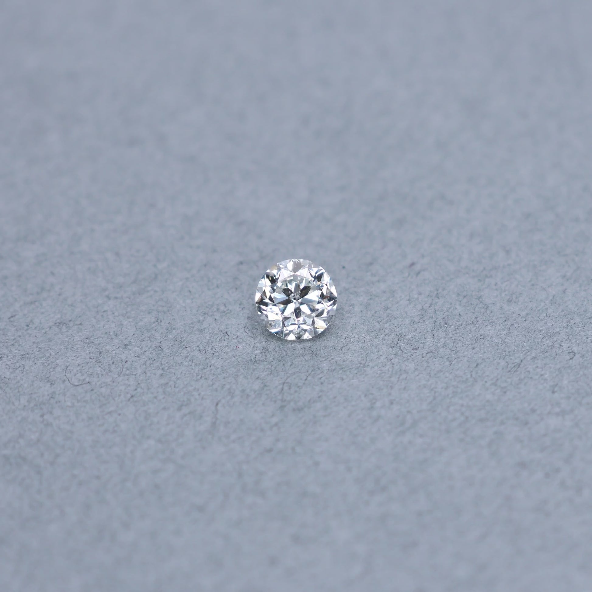 Transitional round 1.02 carat diamond graded GI1 on a grey background