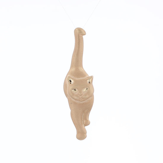 Brushed yellow gold interchangeable pin and pendant of a walking cat on a white background
