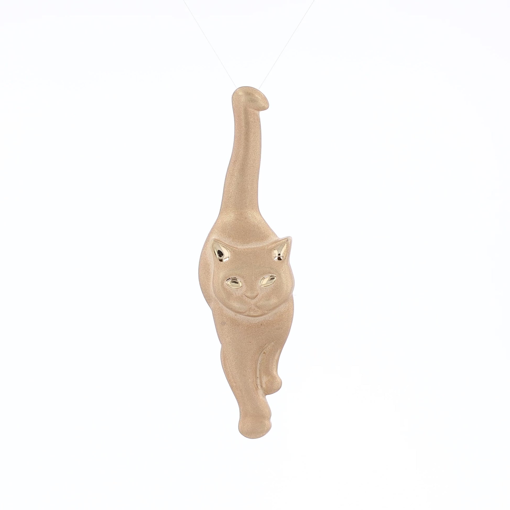 Brushed yellow gold interchangeable pin and pendant of a walking cat on a white background