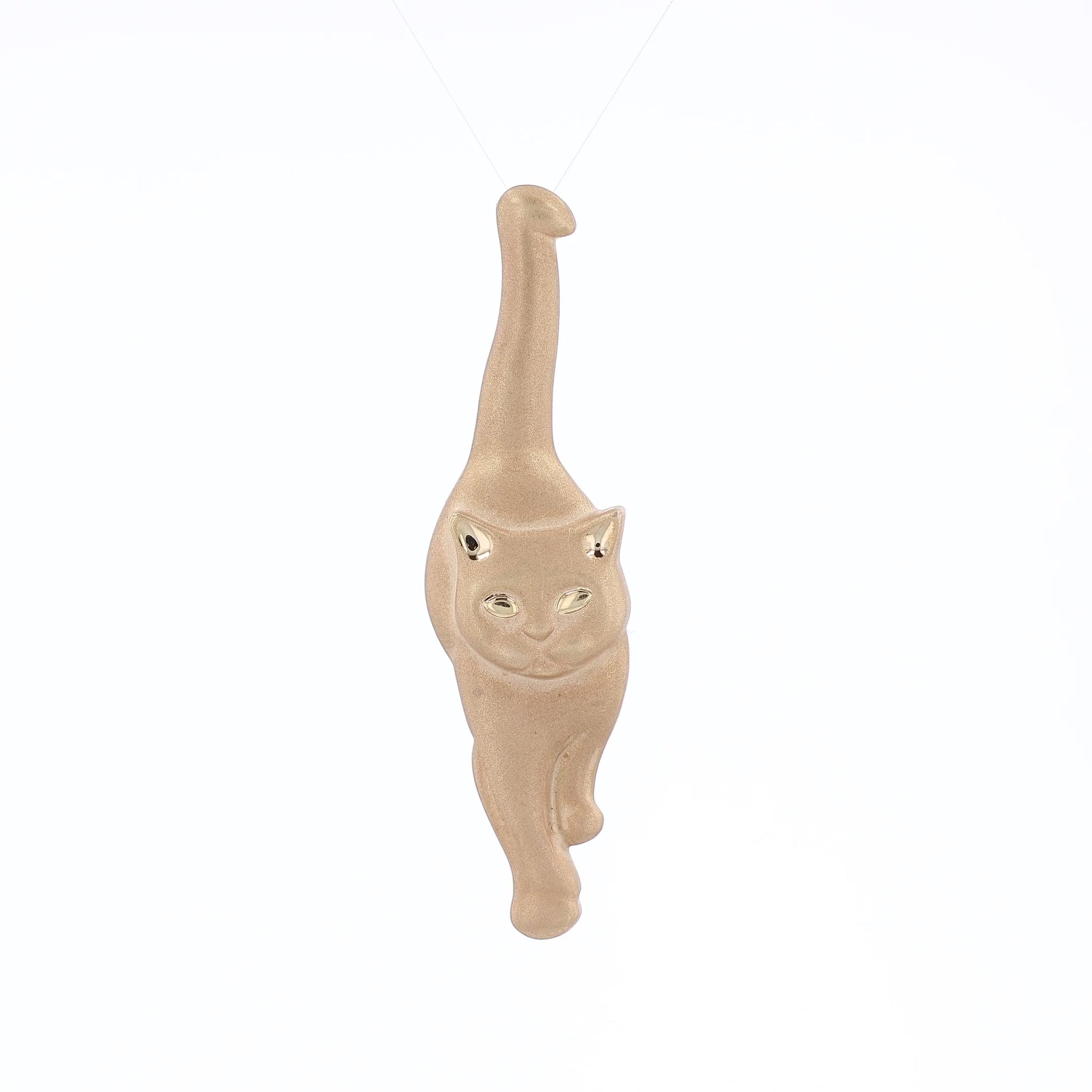 Brushed yellow gold interchangeable pin and pendant of a walking cat on a white background