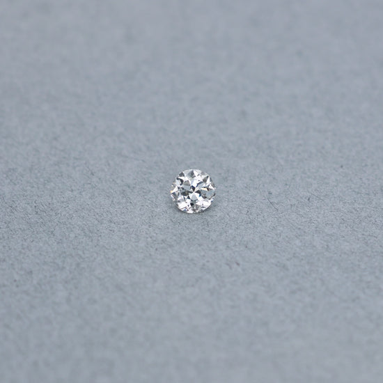 Old european .54 carat diamond graded IVS2 on a grey background