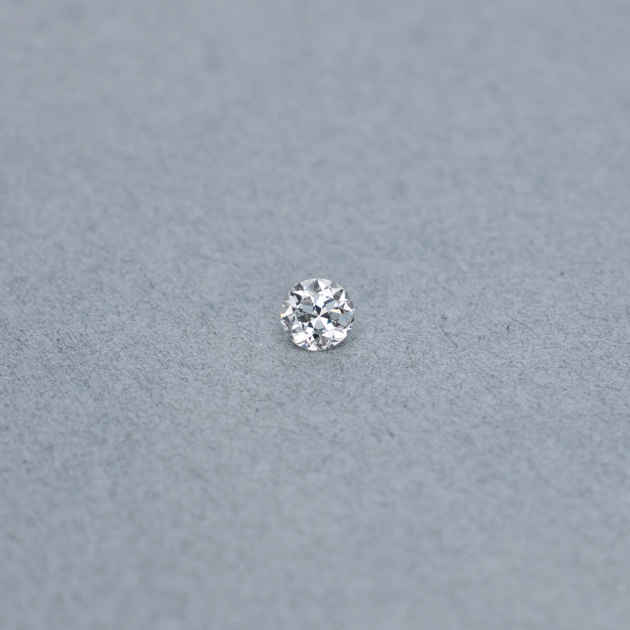 Old european .54 carat diamond graded IVS2 on a grey background
