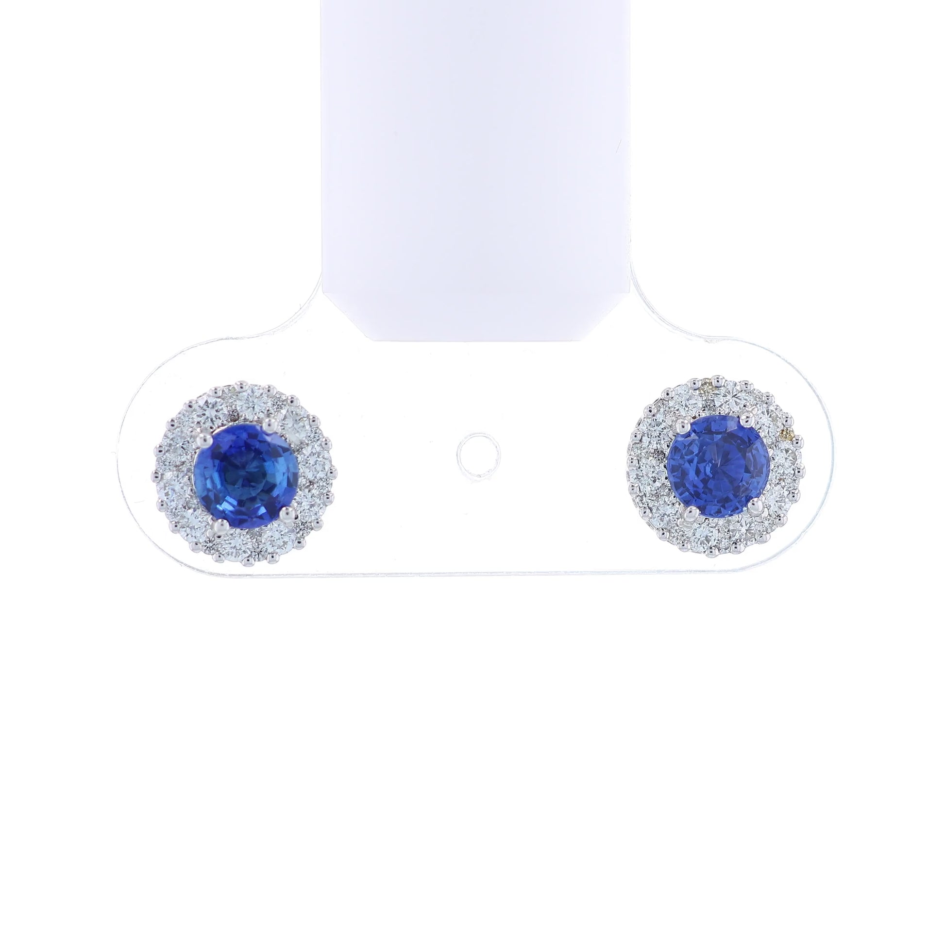 White gold round sapphire and diamond halo stud earrings on a white background