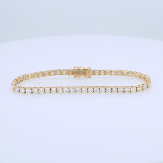 Yellow gold 6.16 carat diamond tennis bracelet on a white background