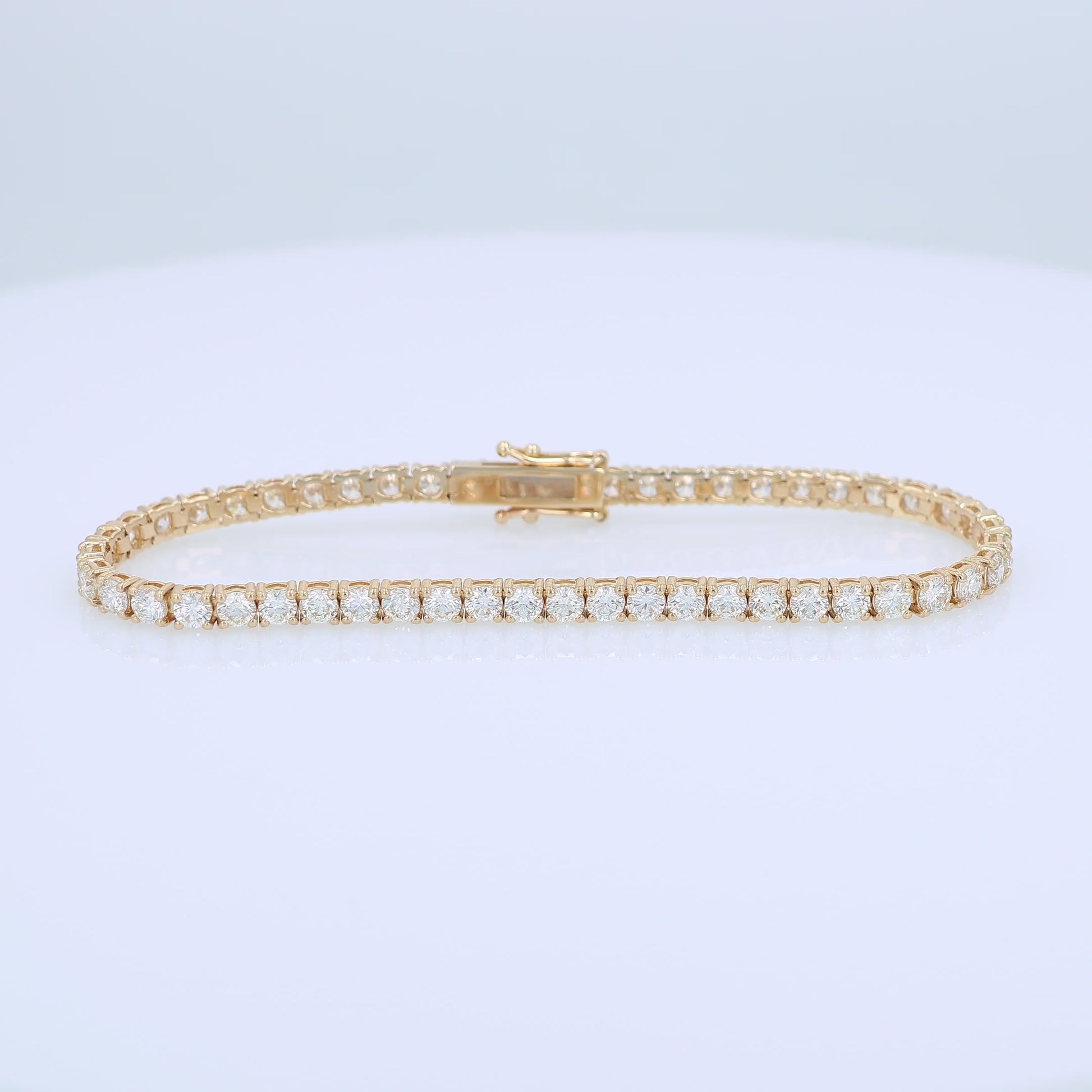 Yellow gold 6.16 carat diamond tennis bracelet on a white background