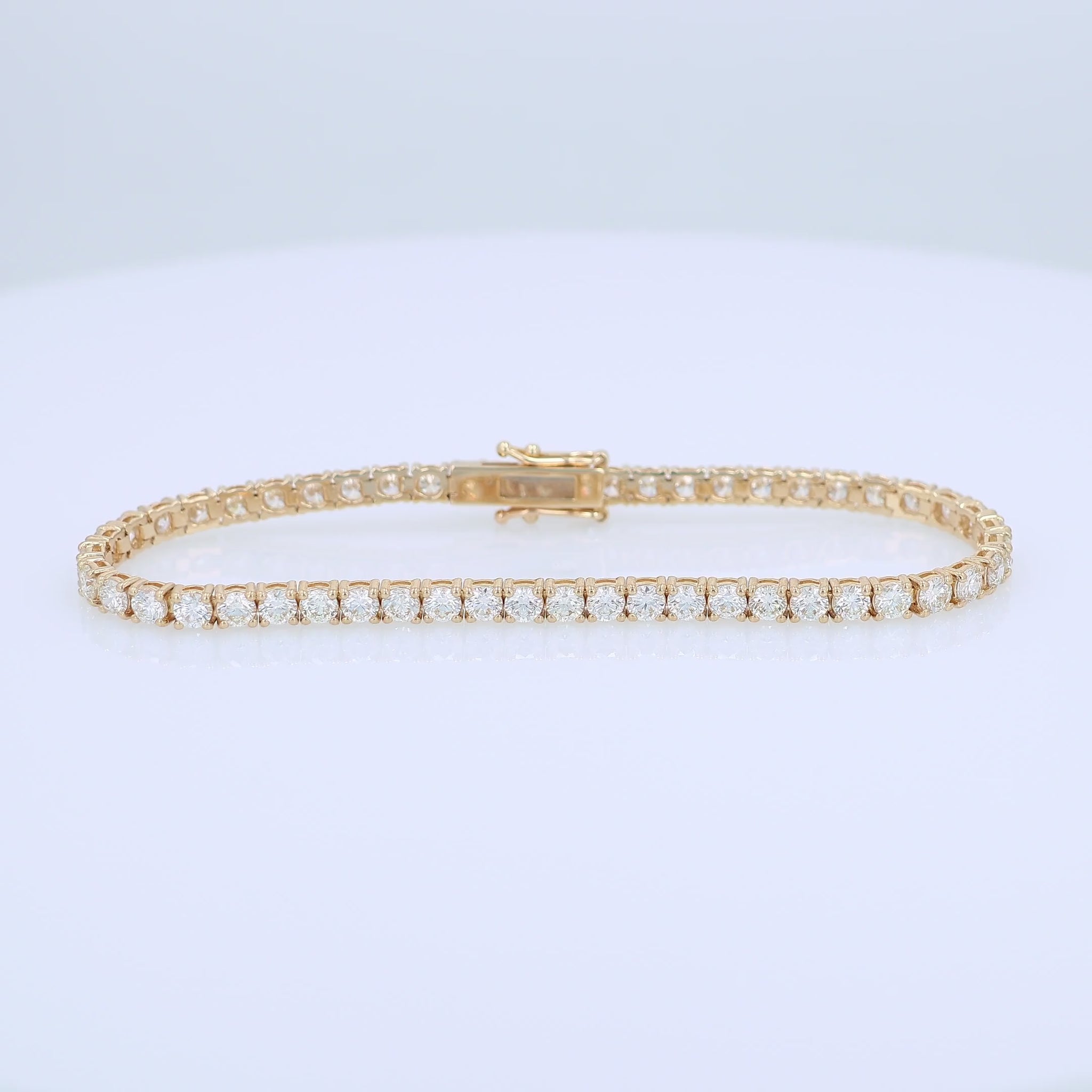 Yellow gold 6.16 carat diamond tennis bracelet on a white background