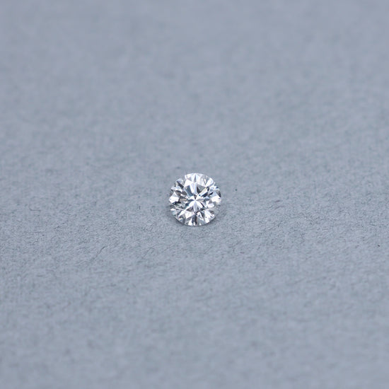Round .82 carat GIA certified diamond graded DSI2 on a grey background