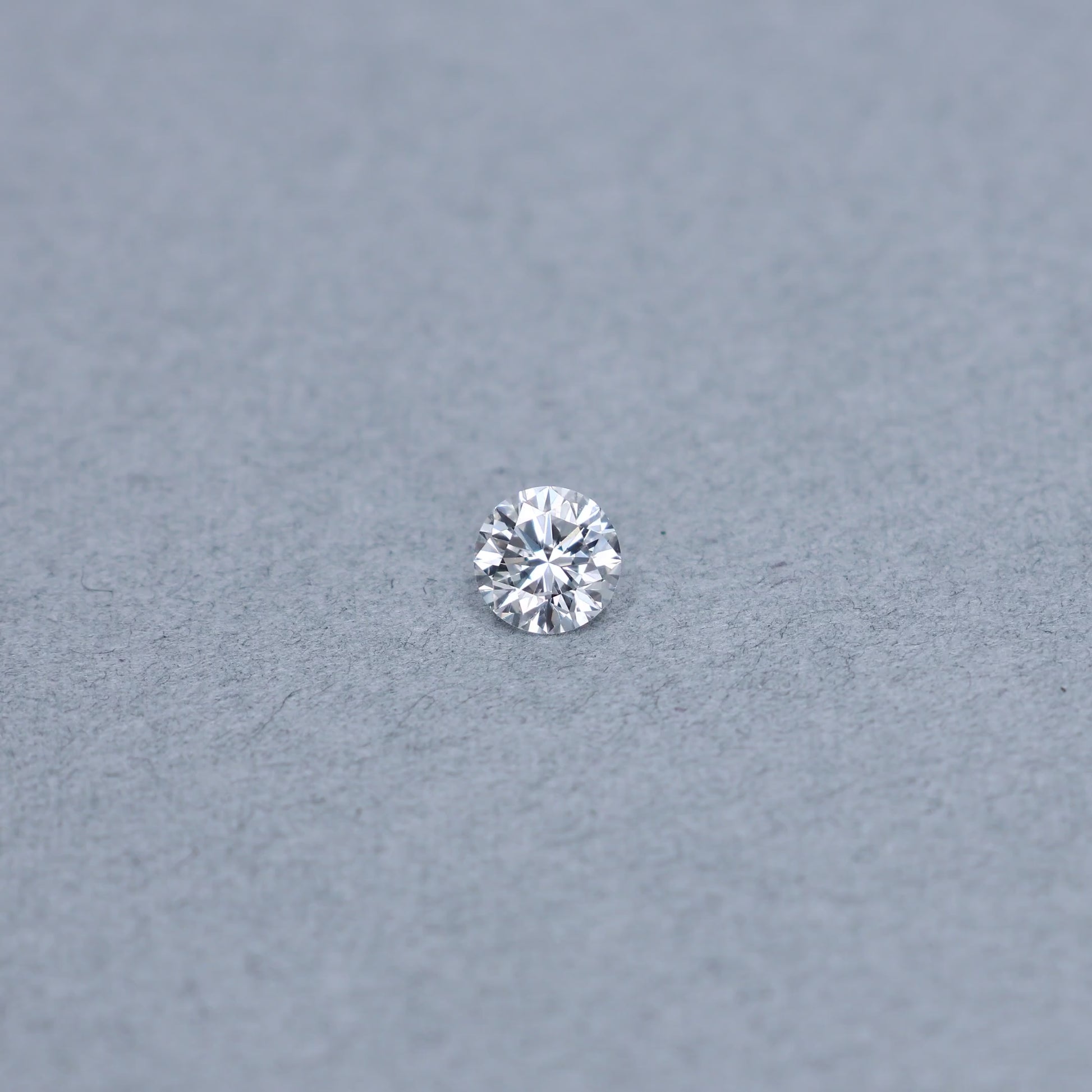 Round .82 carat GIA certified diamond graded DSI2 on a grey background