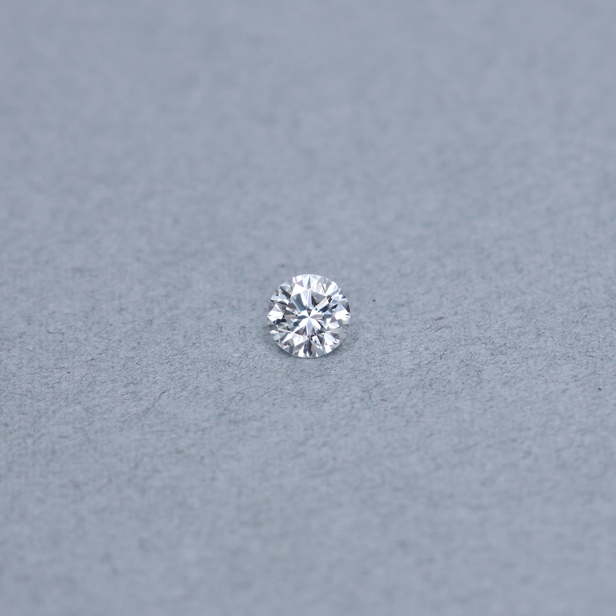 Round .82 carat GIA certified diamond graded DSI2 on a grey background