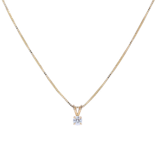 A delicate gold chain necklace with a small pendant holding a clear round-cut diamond, displayed against a solid white background.