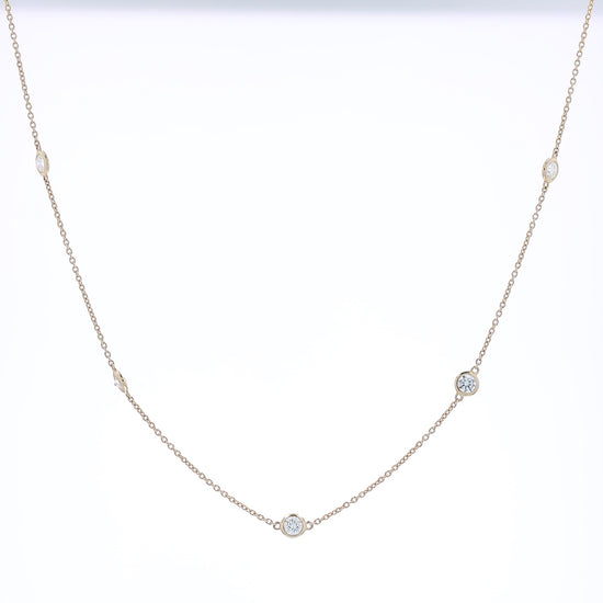Yellow gold Diamonds By The Yard diamond station necklace on a white background