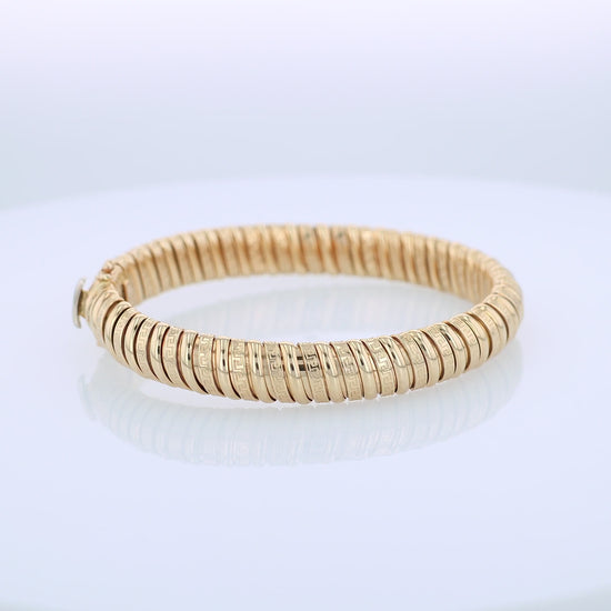 360 degree video of a yellow gold alternating polished and greek key design soft tubogas bangle bracelet on a white background