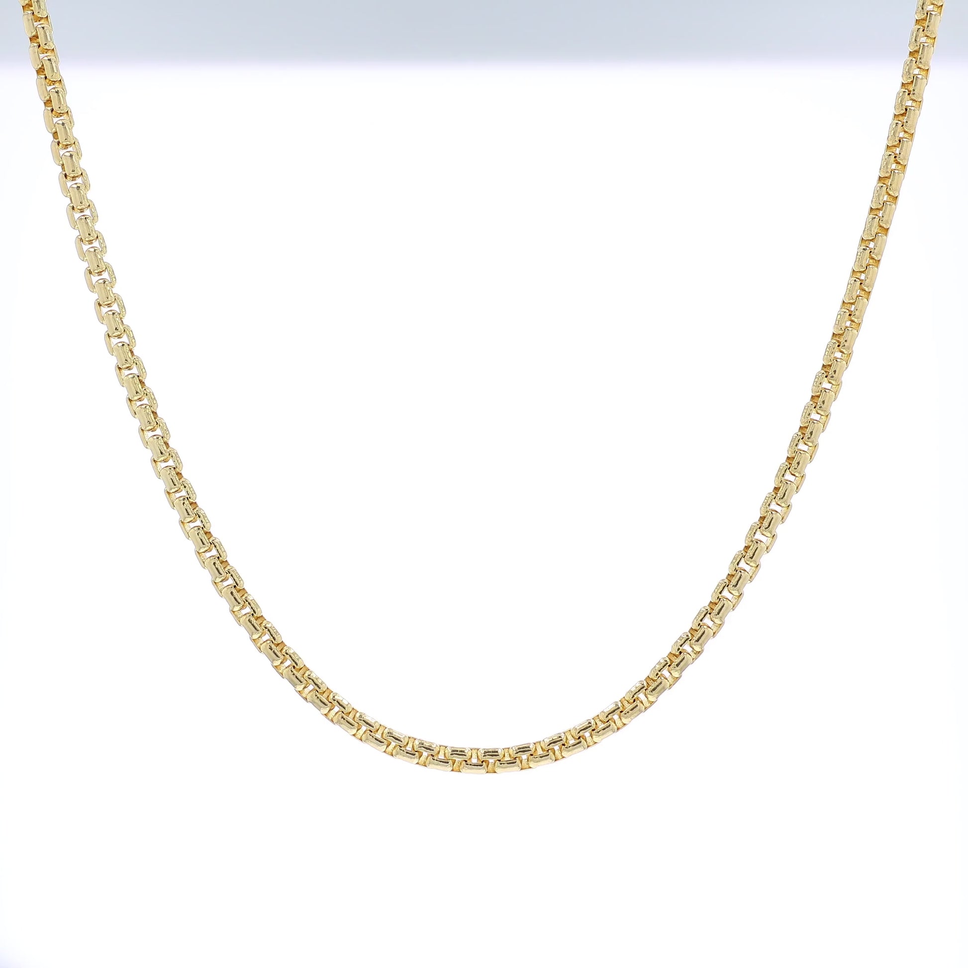 Yellow golf 3.8mm polished box link chain necklace on a white background