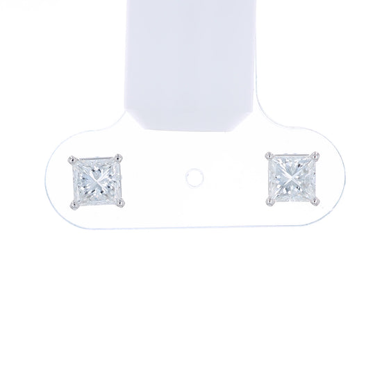 Pair of princess cut diamond stud earrings on a white background