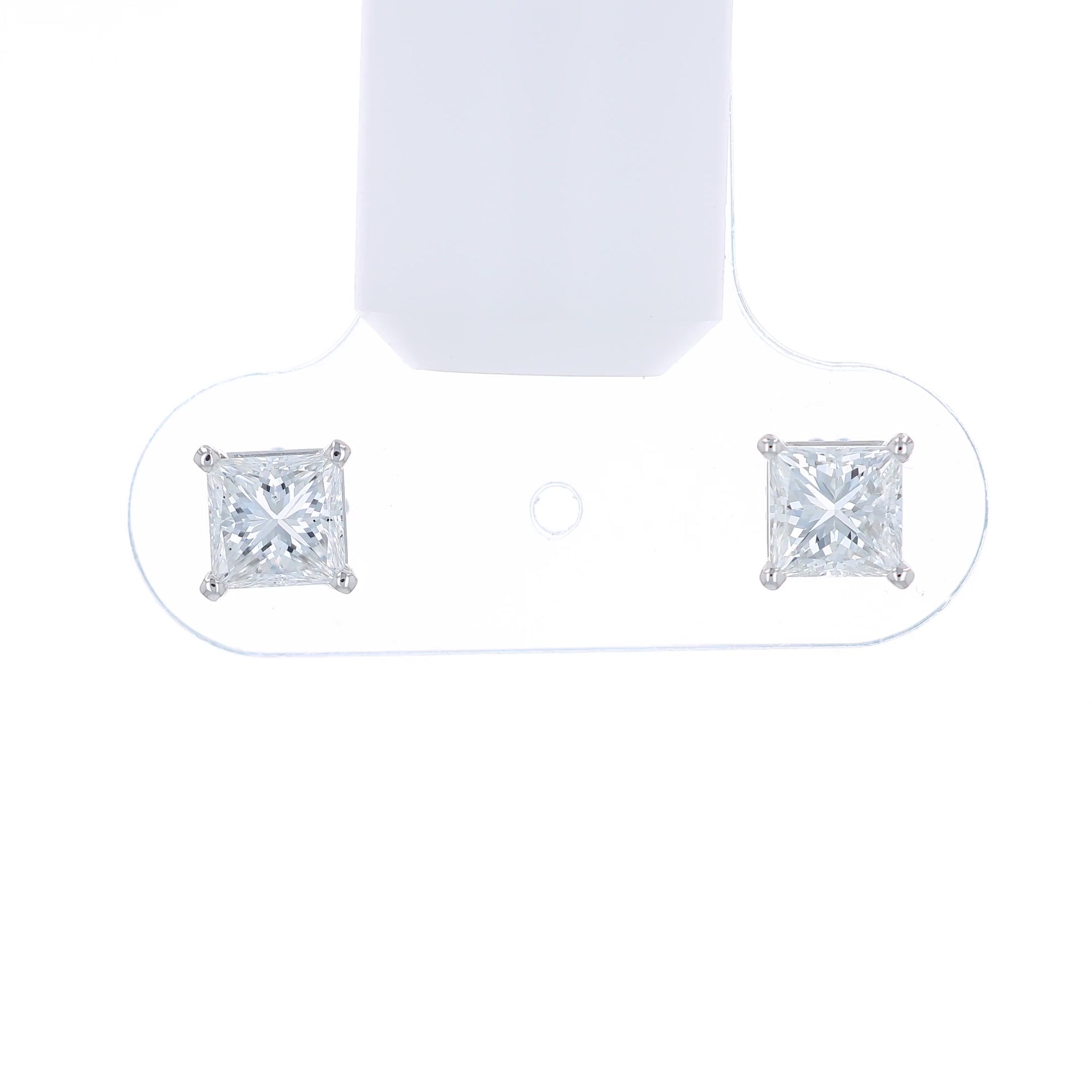 Pair of princess cut diamond stud earrings on a white background