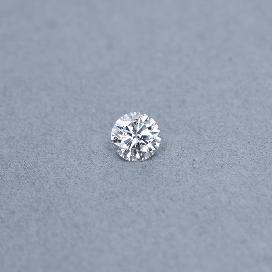 Round 2.00 carat GIA certified diamond graded FI1 on a grey background