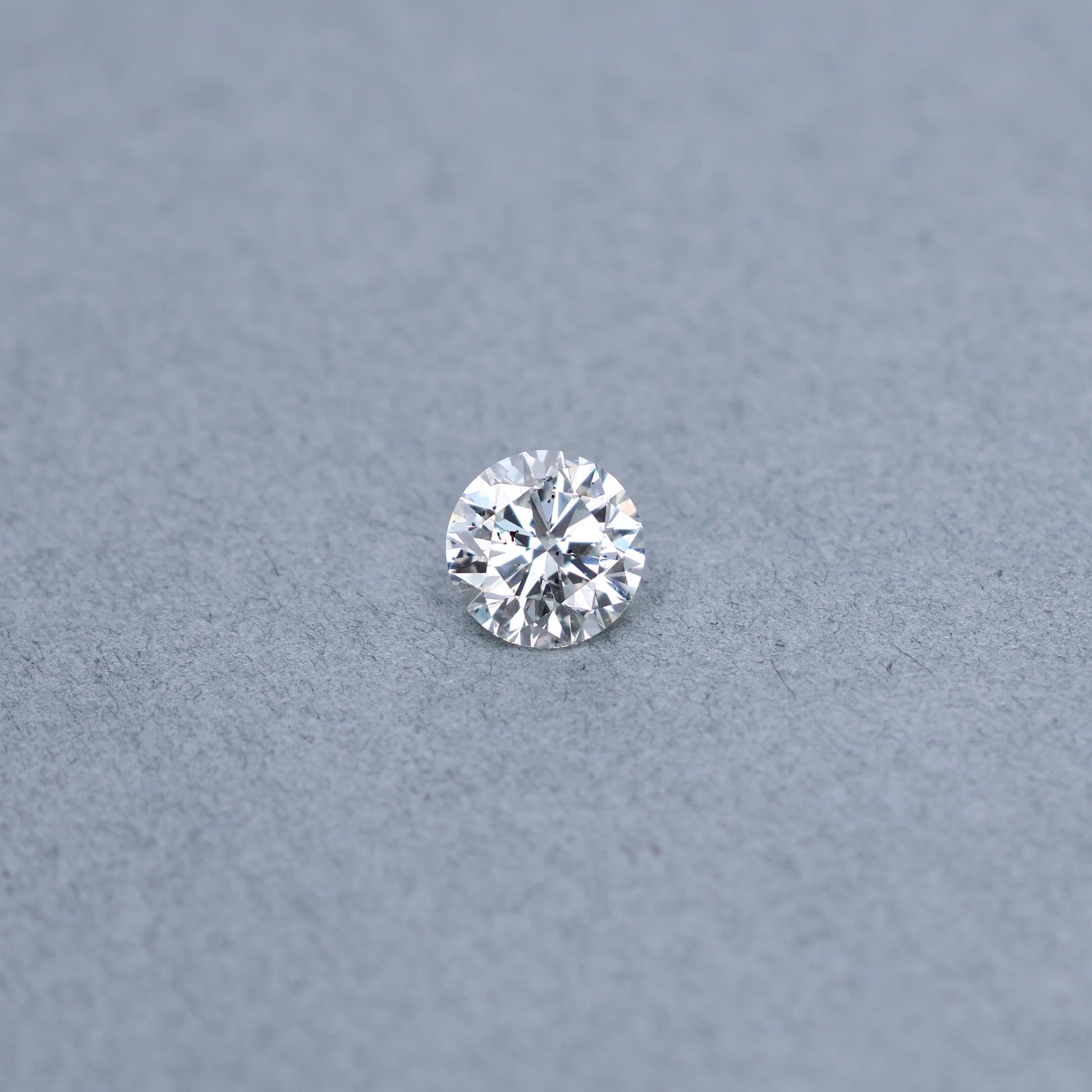 Round 2.00 carat GIA certified diamond graded FI1 on a grey background