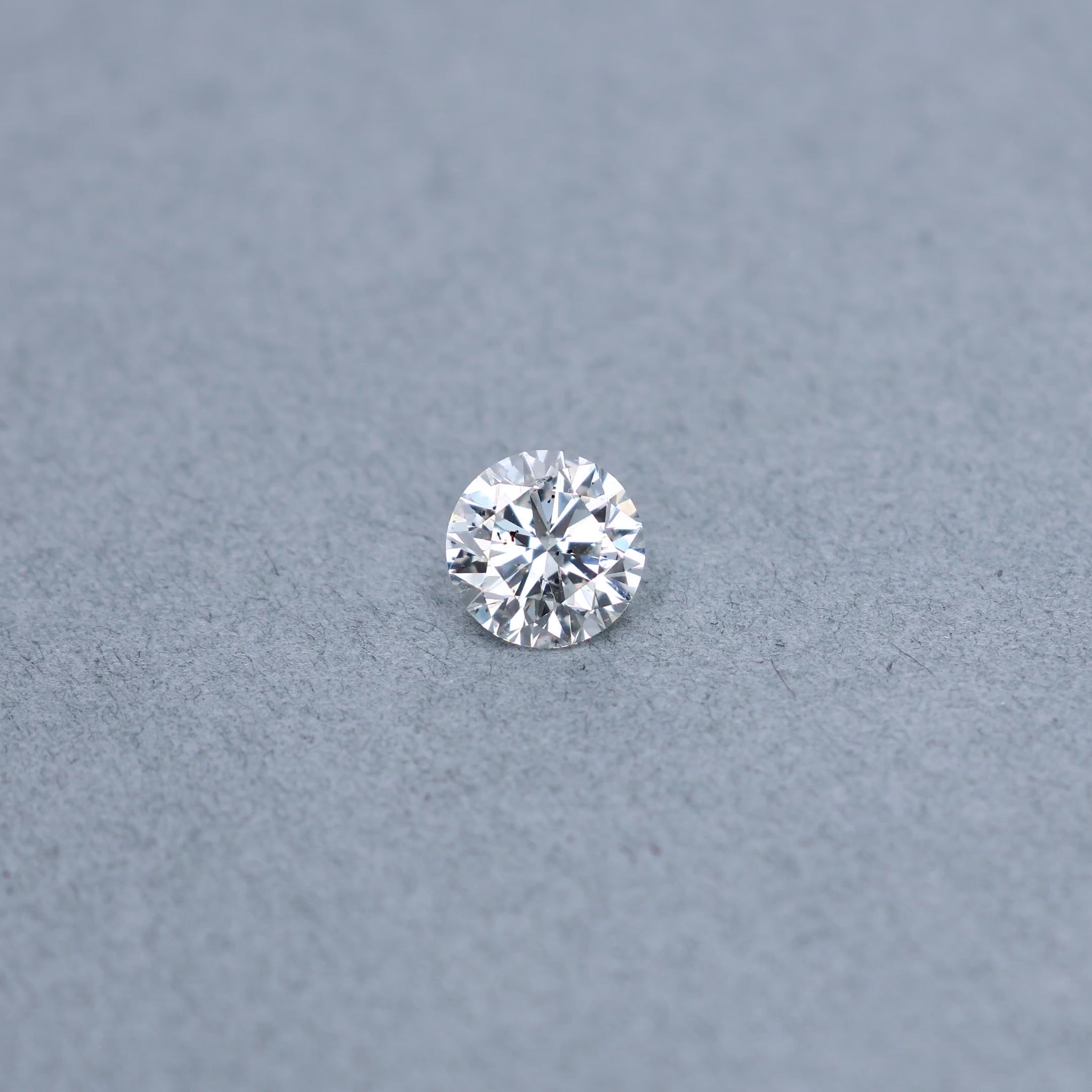 Round 2.00 carat GIA certified diamond graded FI1 on a grey background