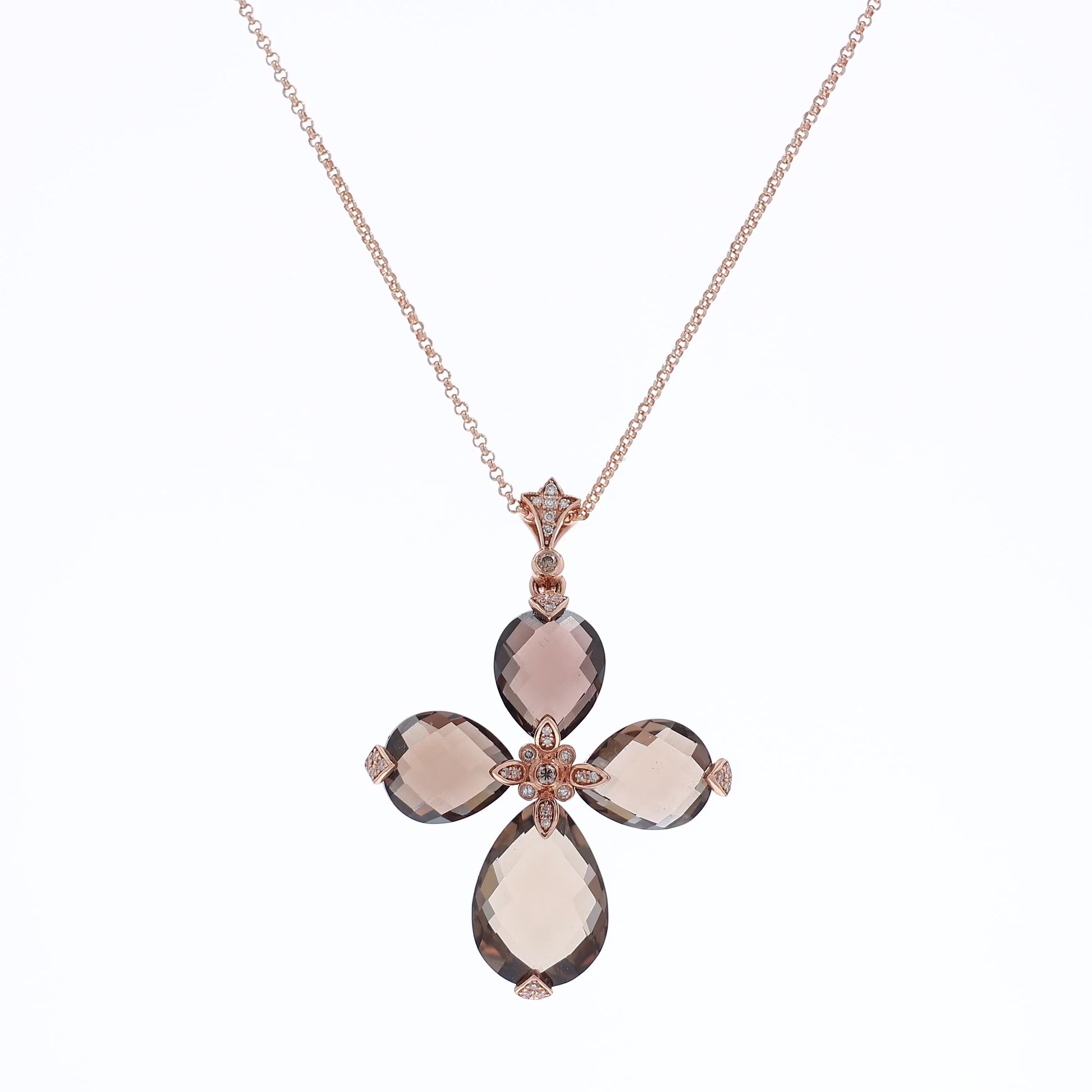 Rose gold faceted pear shape smoky topaz and diamond cross necklace on a white background