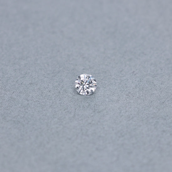 Round .70 carat GIA certified diamond graded DVS1 on a grey background