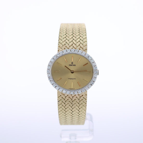 360 degree video of a gold Concord watch with a diamond bezel and a champagne dial on a white background