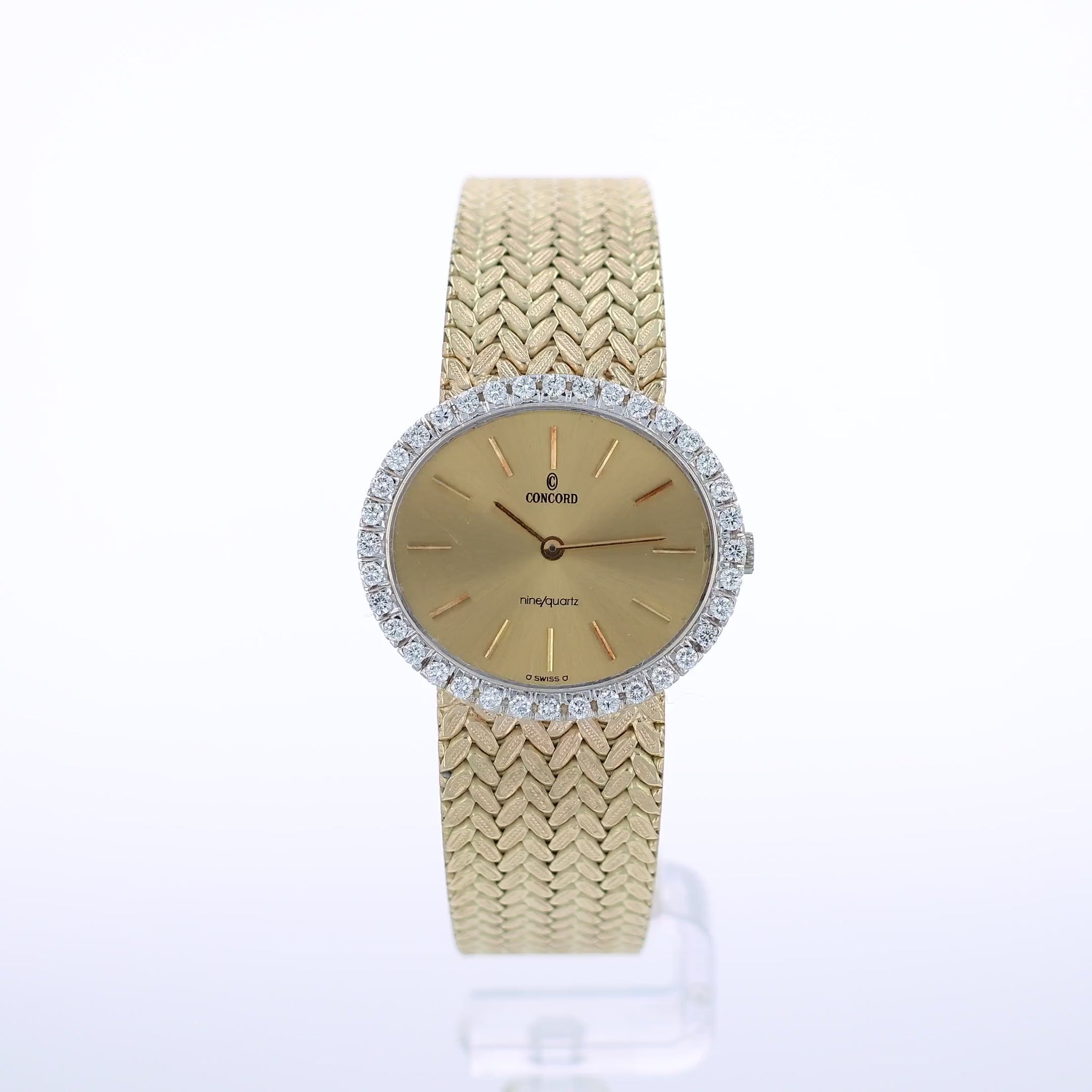 360 degree video of a gold Concord watch with a diamond bezel and a champagne dial on a white background
