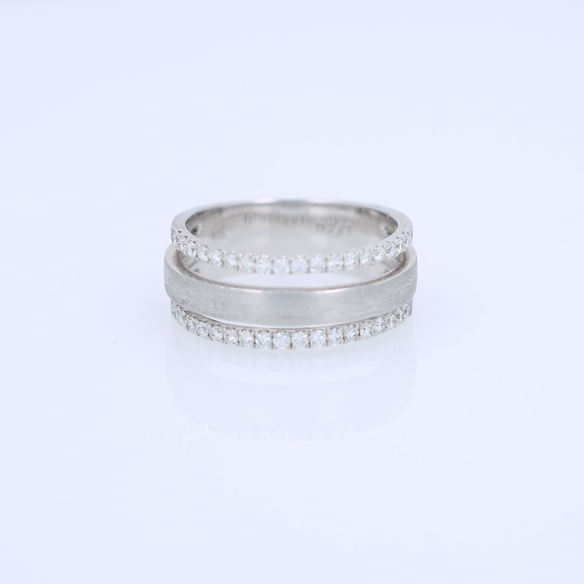 3 row brushed white gold diamond ring on a white background