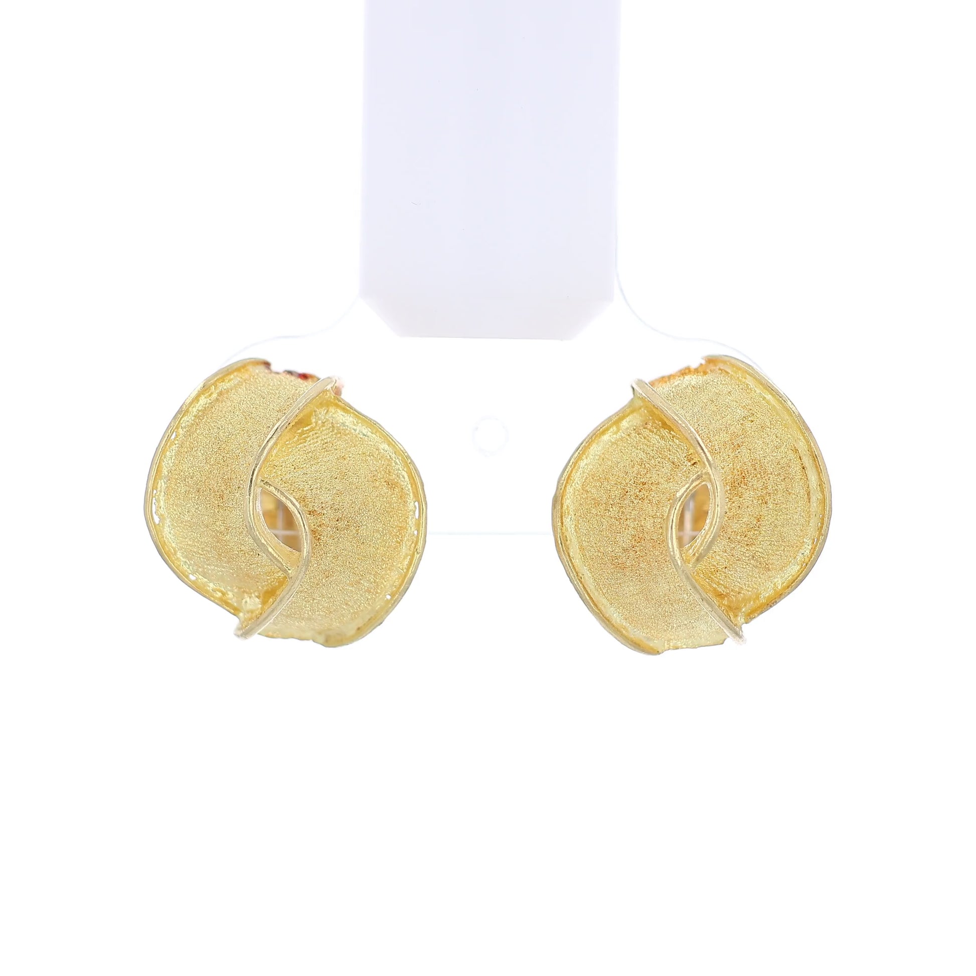 Textured gold earrings on a white background