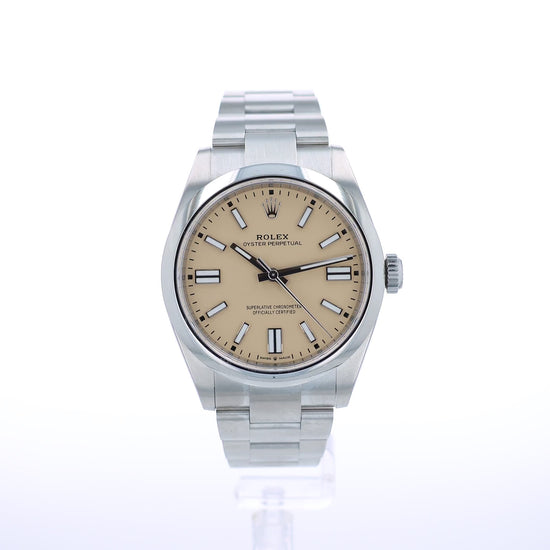 A Rolex Oyster Perpetual watch with a stainless steel bracelet and a beige dial, shown against a plain white background.