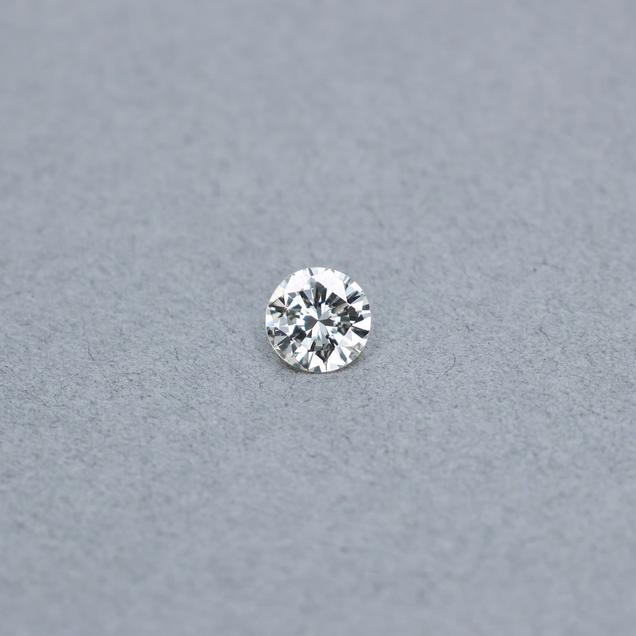Round 1.36 carat diamond graded MVS1 on a grey background